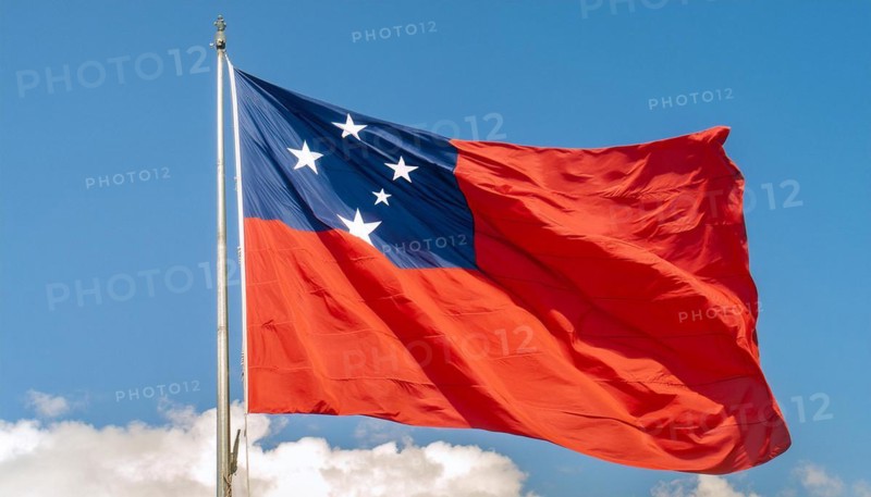 The flag of Samoa, fluttering in the wind, isolated against a blue sky