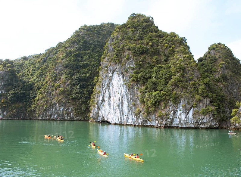 Kayakers and the karst rocks in Lan Ha Bay, Halong Bay, Vietnam, Asia