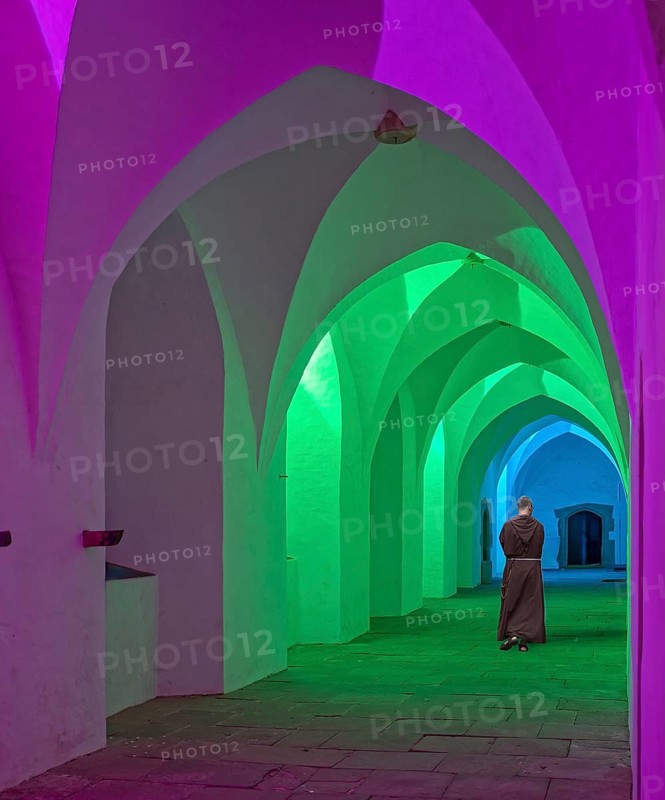Cloister monastery colourfully illuminated with monk Möllenbeck Rinteln Germany