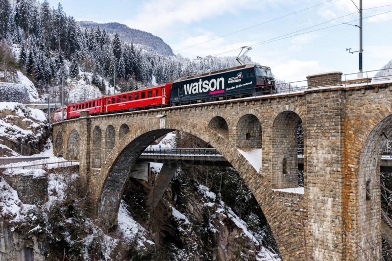 Rhaetian Railway train at the Solis viaduct of the Albula railway in the Alps in Solis, Switzerland, Europe