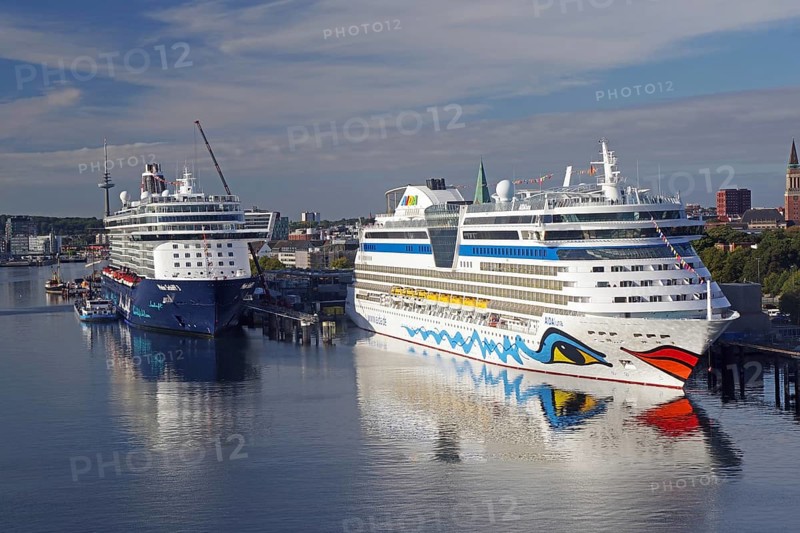 Two large cruise ships in a quiet harbour, with water and city in the background, Aida, Mein Schiff, Kiel Fjord, Kiel, Schleswig-Holstein, Germany, Europe