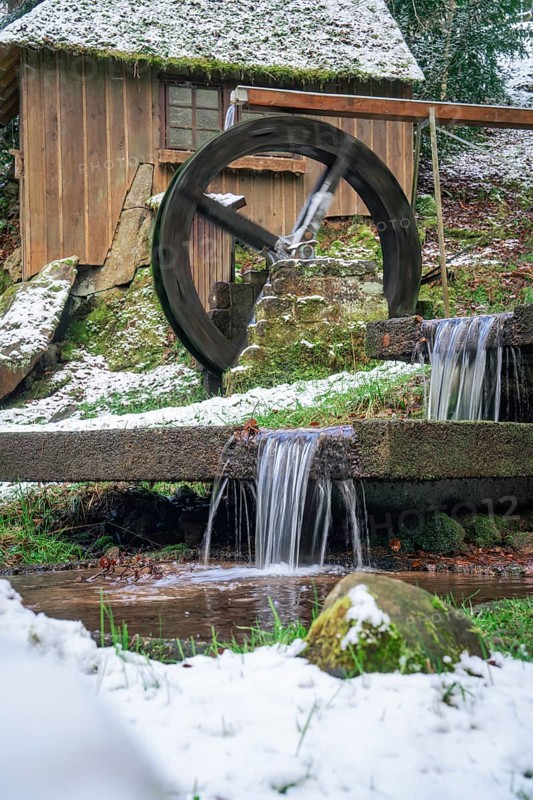 Wooden water mill with running water, snow covers the surroundings, spa gardens, Bad Wildbad, Black Forest, Germany, Europe