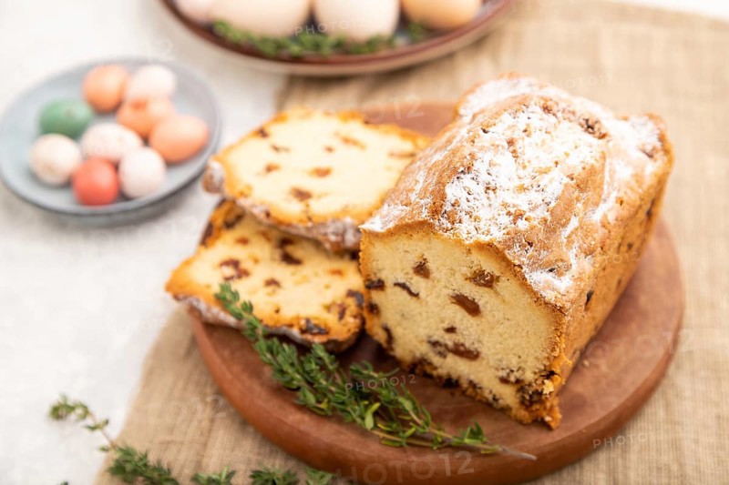 Homemade easter pie with raisins and eggs on plate on a gray concrete background and linen textile. side view, selective focus, close up