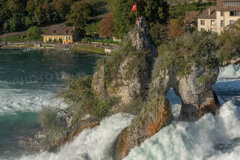 Rhine Falls seen from Laufen Castle, rocky island, Swiss flag, spray, watermill, Canton Zurich, on Neuhausen, Switzerland, Europe