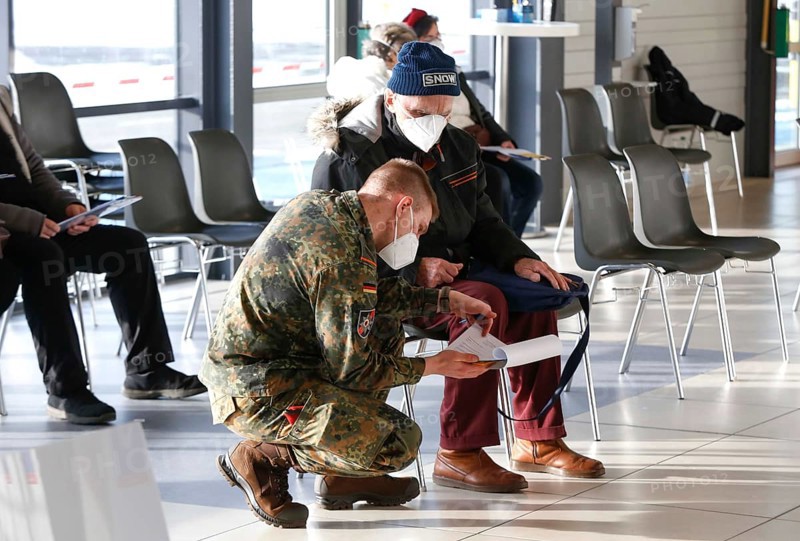 Vaccinees and a soldier of the German Armed Forces in the vaccination centre in Terminal 5 of BER Airport, Schönefeld, 15.02.2021