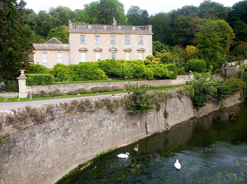 River Frome and the classical Georgian facade of Iford Manor, near Freshford, Wiltshire, England, UK