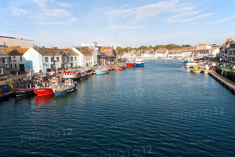 Colourful fishing boats in the harbour at Weymouth, Dorset, England, UK