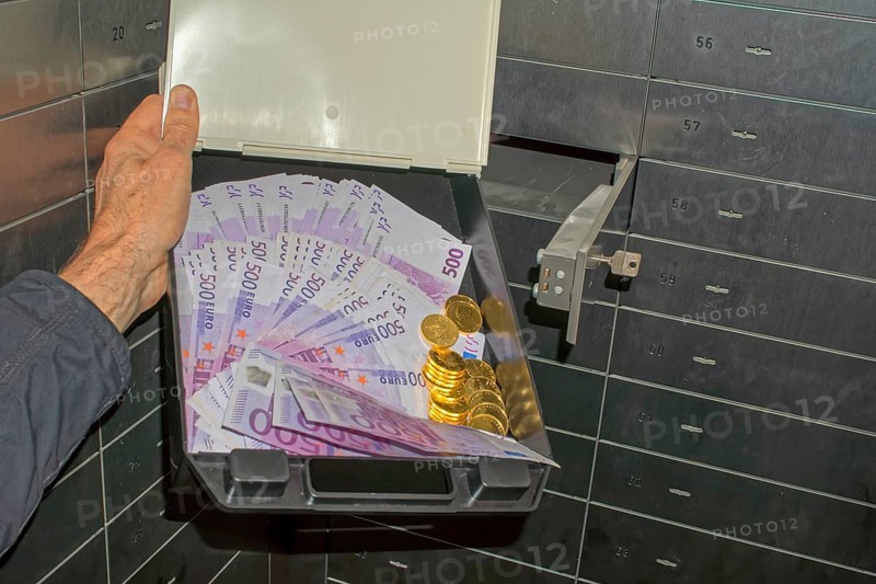 Money and gold in a bank safe deposit box