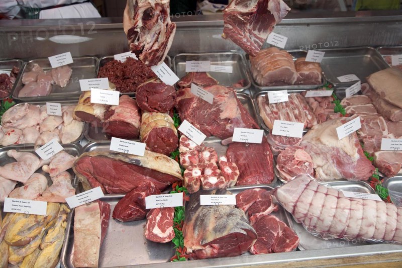 Cuts of meat in shop window of butcher shop, Green Street, Bath, Somerset, England, UK