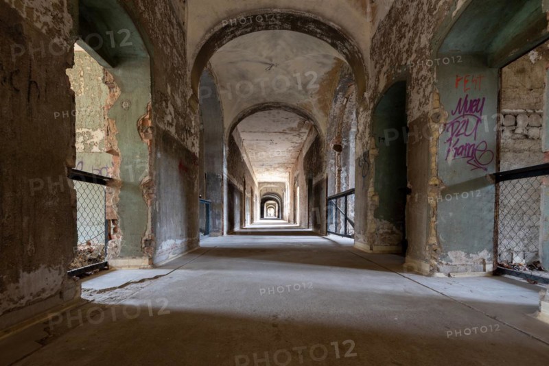 Long empty corridor with peeling paint and graffiti stretching into the distance, Beelitzheilstätten, former lung sanatorium, Beelitz, Brandenburg, Germany, Europe