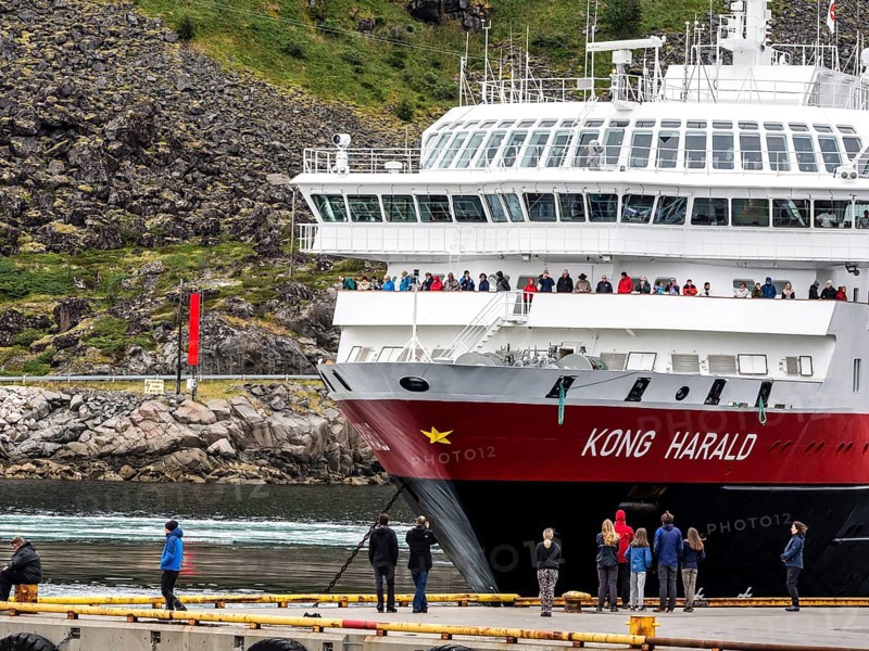 Ship 'Kong Harald' of Hurtigruten company is approaching pier, harbor of Stamsung, on landing, island Vestvagøy, Lofoten, Norway, Europe