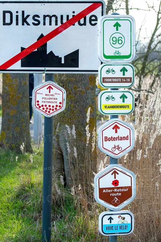 Bike node sign and 14-18 front route signposts giving directions for cycling routes, bicycle tourism at Diksmuide, Dixmude, West Flanders, Belgium, Europe