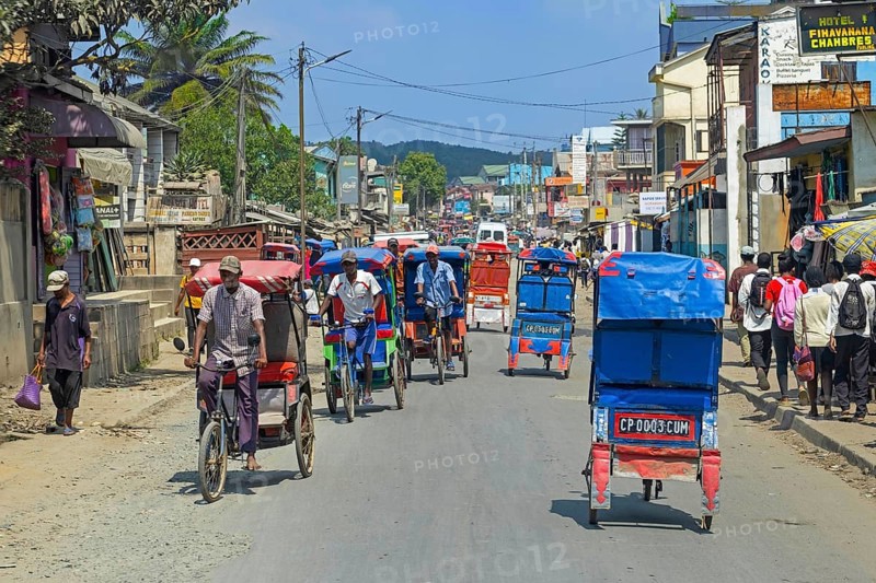 Cycle rickshaws, cyclo-pousses, velotaxis in bust street in the city Moramanga, Alaotra-Mangoro Region, Eastern Madagascar