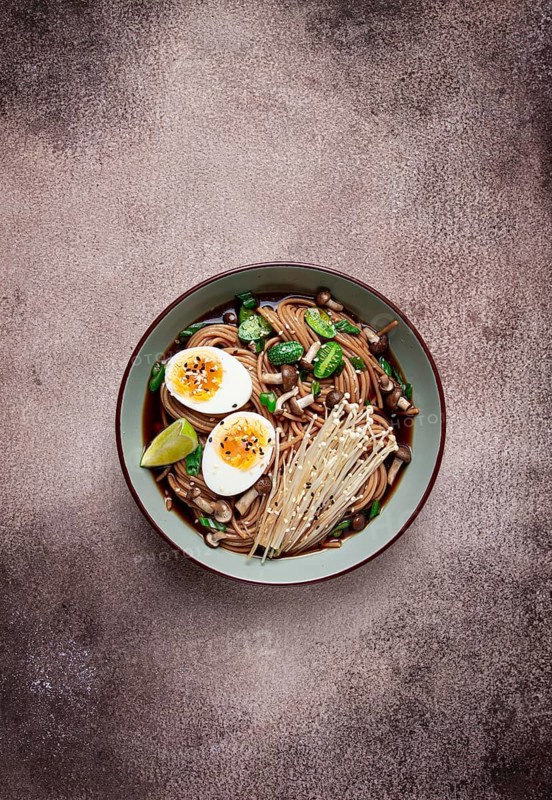 Soba, buckwheat noodles, with enoki mushrooms, shimeji and boiled egg, top view, homemade, no people