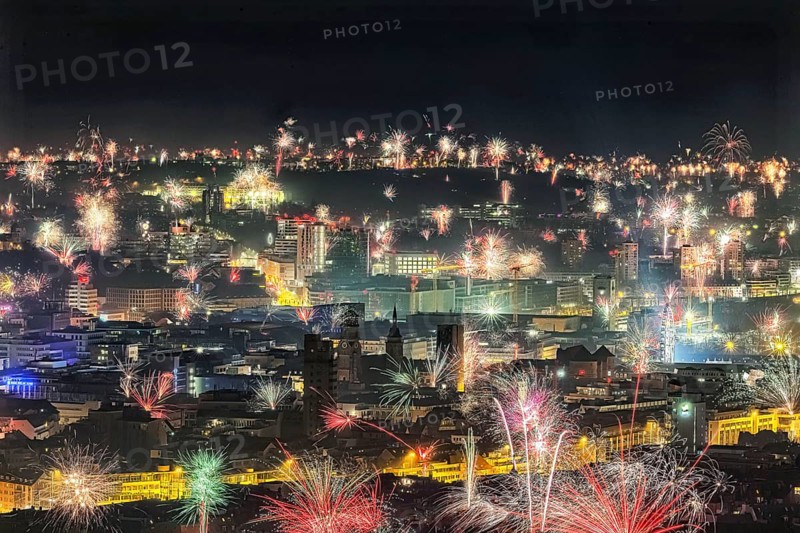Stuttgart welcomes the New Year 2024 with fireworks over the city centre. In the centre of the picture: town hall tower, collegiate church and Old Palace, Stuttgart, Baden-Württemberg, Germany, Europe