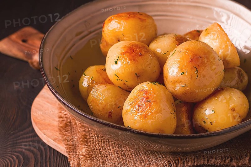 Fresh Cooked, new potatoes, with dill, on a wooden table, selective focus. close-up, toning, no people