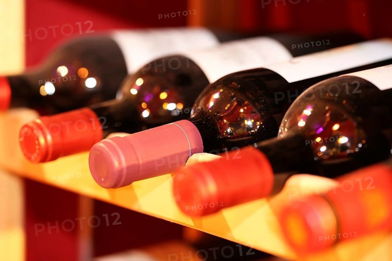 Wine cellar with red wine bottles