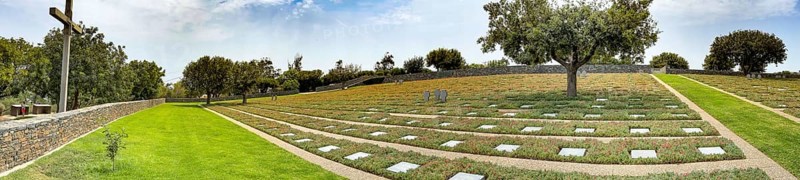 Panoramic photo wide view over part of German military cemetery inaugurated in 1974 by Volksbund Deutsche Kriegsgräberfürsorge on former battlefield in World War II heavily contested hill Height 107, Maleme, Crete, Greece, Europe