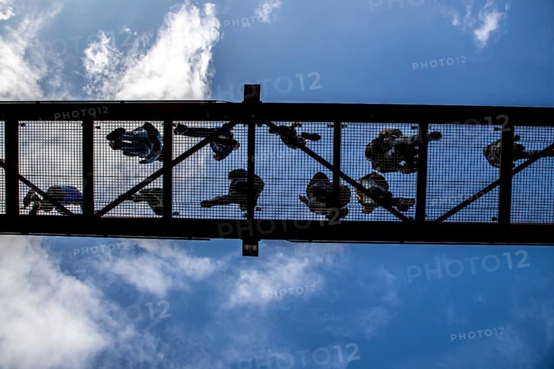 Lattice walkway, people walk over a walkway at a height of a good 15 metres, made of steel lattice, seen from below, viewing platform