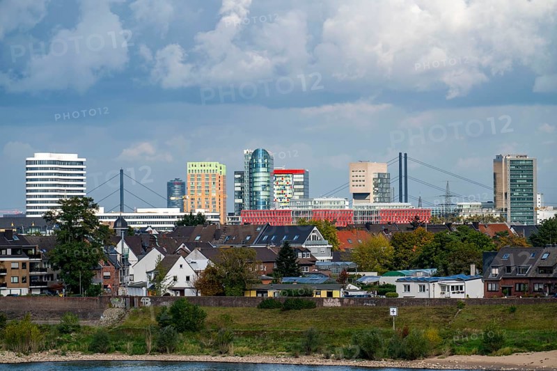 The skyline of Düsseldorf, with the skyscrapers in the Media Harbour, Rhine bridges, in front residential buildings on the Rhine in the Hamm district, Düsseldorf, North Rhine-Westphalia, Germany, Europe