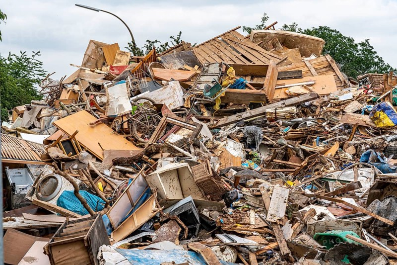 Flood on the Erft, on the outskirts of the Bliesheim district, Erftstadt, the household rubbish was stored, which was taken from the flats and houses of the village after the flooding of the village, from here it is taken by lorry to landfills, North Rhine-Westphalia, Germany, Europe