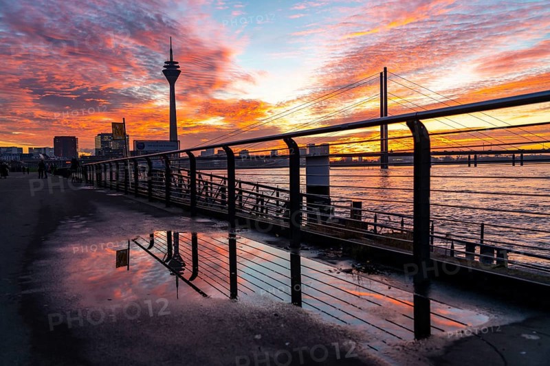 Winter sunset on the Rhine near Düsseldorf, riverside promenade at the old town, Rhine Tower, cargo ship, Rheinkniebrücke, North Rhine-Westphalia, Germany, Europe