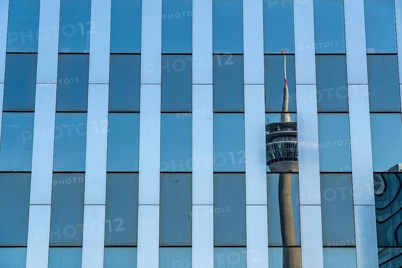 The Rhine Tower reflected in a glazed façade, RWI building, Düsseldorf, North Rhine-Westphalia, Germany, Europe