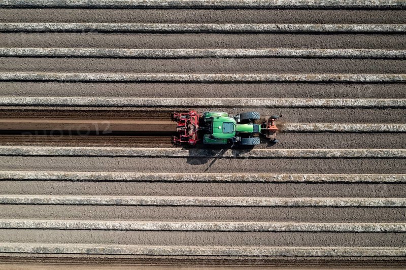 A farmer builds asparagus ridges on a field with the help of an asparagus tiller, in which the asparagus then grows, Dormagen, North Rhine-Westphalia, Germany, Europe