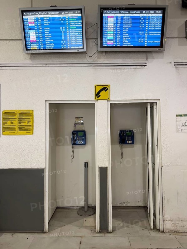 Payphones, cabins, in the departure hall of Heraklion airport on the Greek island of Crete, monitors with departure information