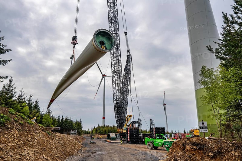 Erection of a wind turbine, wind energy plant, assembly of the third blade, with a crawler lattice crane, wind farm near Hagen, North Rhine-Westphalia, Germany, Europe