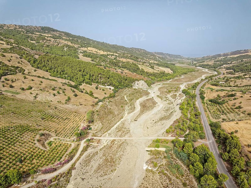 The dry riverbed of the Canale Raia, which is fed by the Torrente del Ferro torrent with water from the mountains after heavy rainfall. Aerial photo. Amendolara, Cosenza, Calabria, Southern Italy, Southern Europe