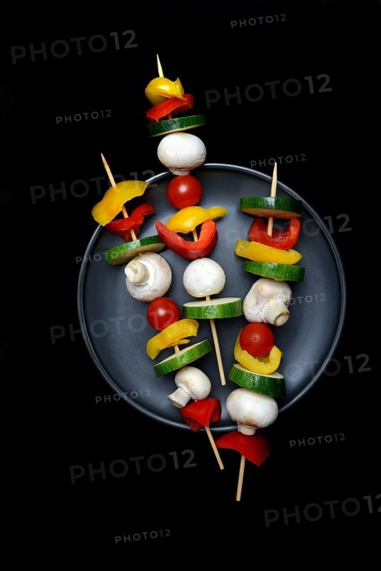 Colourful vegetable skewers on a plate, barbecue skewers