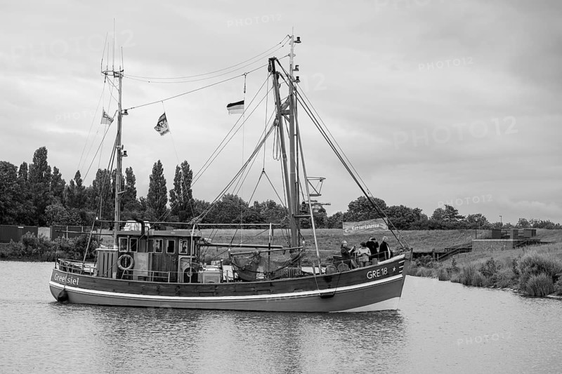 Fishing boat entering the harbour, Greetsiel, East Frisia, Lower Saxony, Germany, Europe