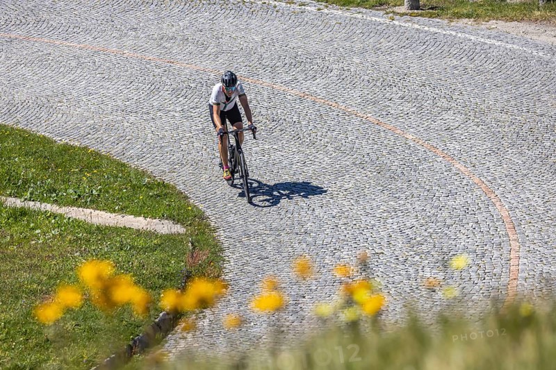 Cyclists on the road on La Tremola, the world-famous Alpine pass through the Val Tremolo, Switzerland's longest road construction monument with 24 hairpin bends. Airolo, Canton Ticino, Switzerland, Europe