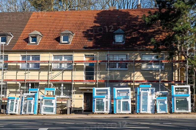 Energy-efficient refurbishment of residential buildings, older apartment block is scaffolded, gets thermal insulation and new windows, Germany, Europe