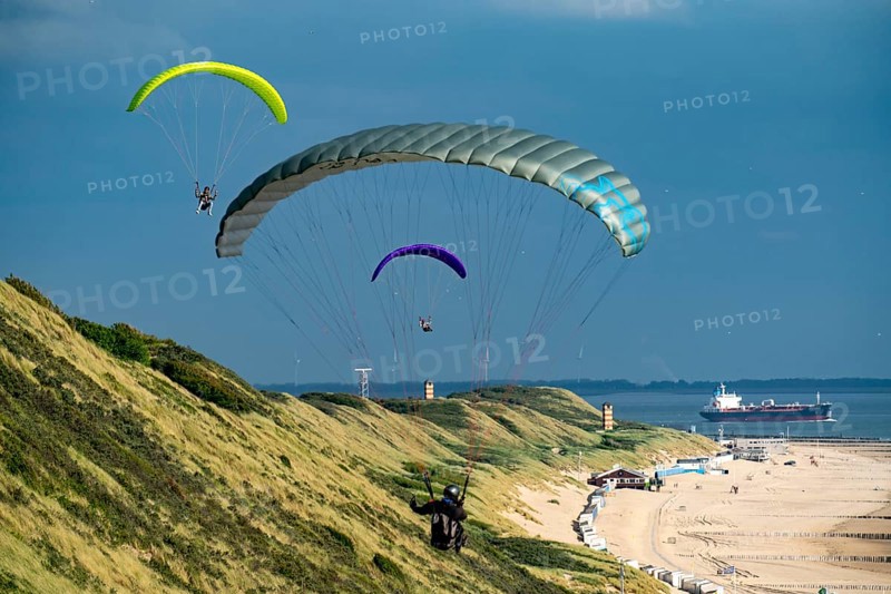 Paragliders along the dunes of Zoutelande, in Zeeland, South Holland, Netherlands