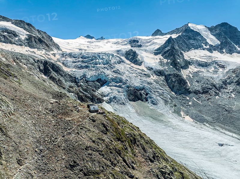 Mountain hut Cabane de Moiry, located close to the retreating Moiry glacier, hiking trail, aerial view, Valais, Switzerland, Europe