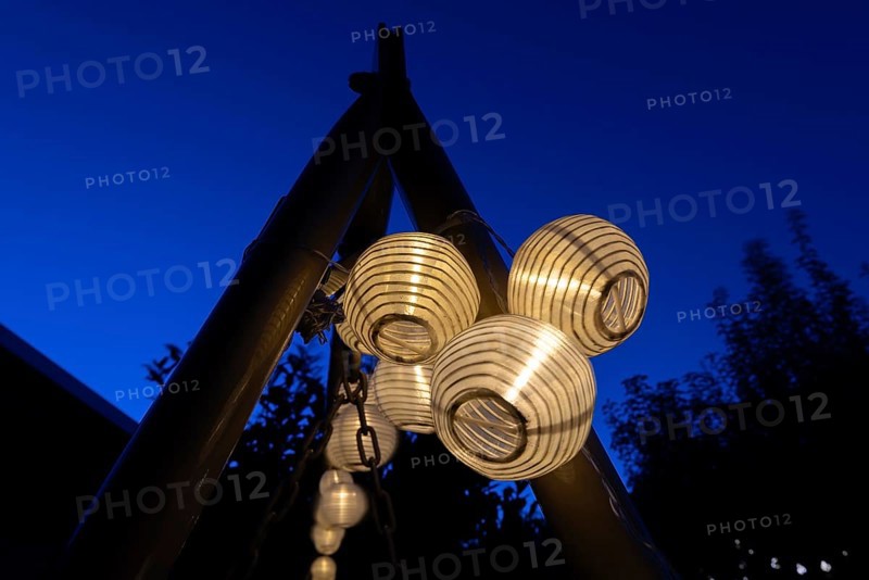 Lanterns, paper lanterns, fairy lights in a garden, blue hour, Germany, Europe