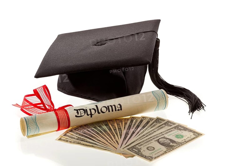 A doctor's hat and dollar bills, symbol of education costs in America, tuition fees, Vienna, Austria, Europe