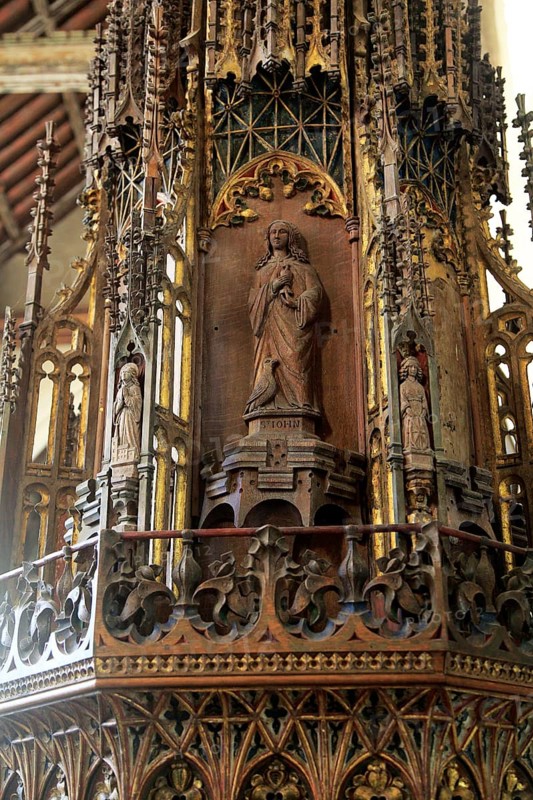 Ornately decorated large wooden baptismal font cover Ufford church, Suffolk, England, UK