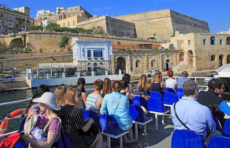 People onboard ferry boat crossing harbour from Sliema to Valletta, Malta, Europe