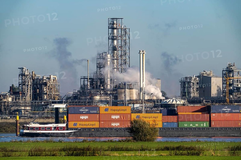Cargo ship on the Rhine near Emmerich, Kao Chemicals backdrop, specialising in surfactants, KLK, Left Rhine pastures, Lower Rhine, North Rhine-Westphalia, Germany, Europe