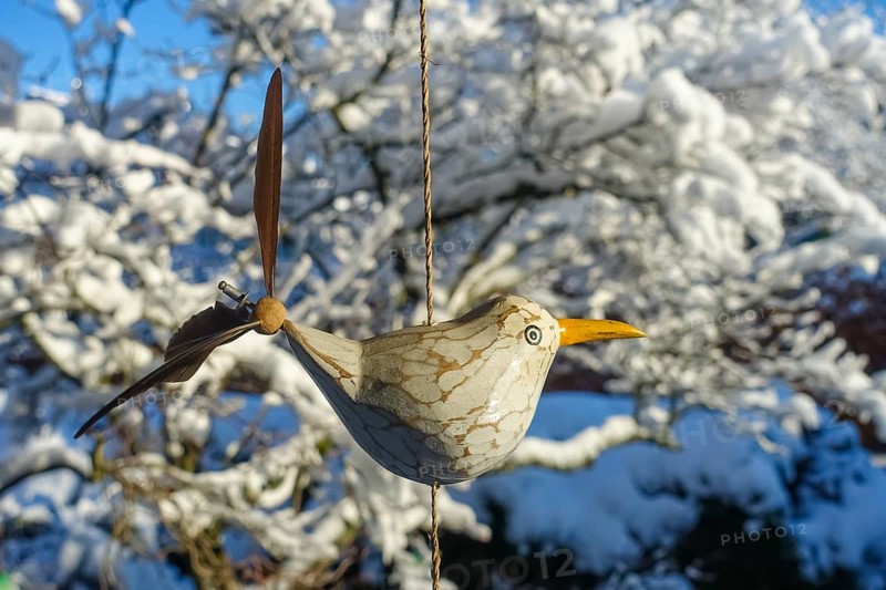 Wind chime, bird, tail feathers, replica, seagull, small figure, snow behind, twigs, Germany, Europe
