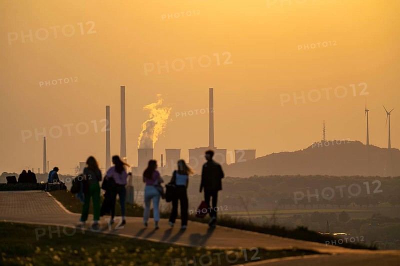 Evening atmosphere on the Hoheward spoil tip, the largest spoil tip in the Ruhr area, between Herten and Recklinghausen, with the Scholven power station in Gelsenkirchen, North Rhine-Westphalia, Germany in the background