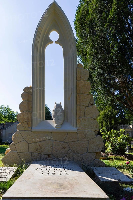 A new monument can be seen at Caspar David Friedrich's grave in Dresden's Trinitatisfriedhof cemetery to mark the 250th birthday of the most famous Romantic artist. The Gothic church window made of sandstone with an owl in rear view on the ledge. The construction was supported by the actor and Friedrich admirer Tom Pauls, Grave of Caspar David Friedrich, Dresden, Saxony, Germany, Europe