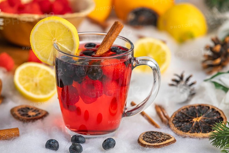 Punch with raspberries, blueberries, lemon and cinnamon, Christmas atmosphere