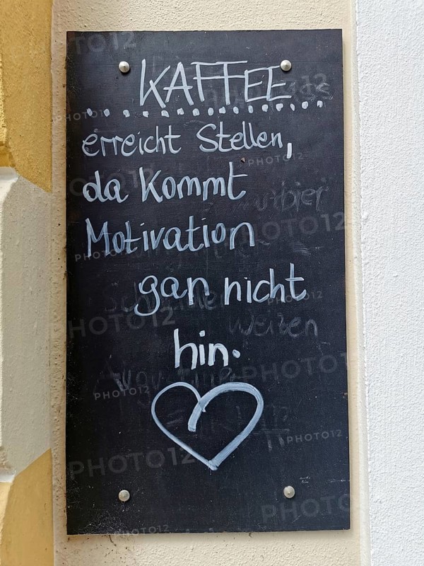 Advertising sign at an inn, coffee reaches places where motivation does not reach, slate sign