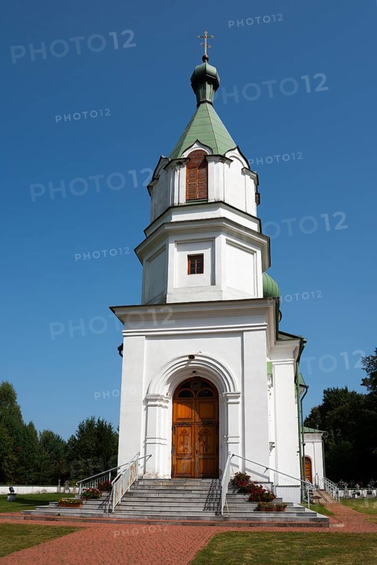 Detailed view of a white church with a green tower, surrounded by landscaped paths under a blue sky, Orthodox Church of St Nicholas, Narewka, Podlaskie Voivodeship, Podlaskie, Poland, Europe