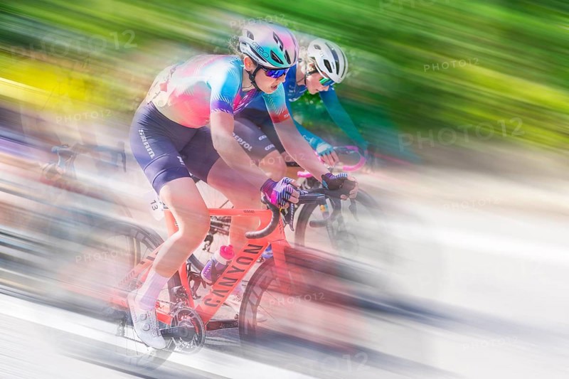 Two female cyclists in sportswear and helmets riding at high speed on a road, racing, the blur of movement emphasises the speed, Stuttgart, Baden-Württemberg, Germany, Europe