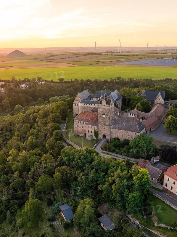 Bird's eye view of the castle with surrounding forests and fields at sunset, Allstedt, Harz, Germany, Europe